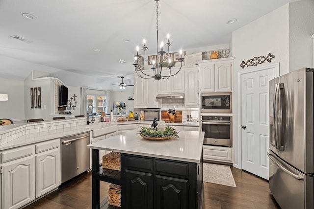 416 Springhill Dr, Hurst, TX 76054 - kitchen with stainless steel appliances, a peninsula, white cabinetry, light countertops, and recessed lighting