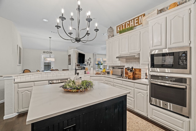 416 Springhill Dr, Hurst, TX 76054 - kitchen featuring stainless steel appliances, a peninsula, white cabinets, light countertops, and recessed lighting