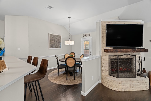 416 Springhill Dr, Hurst, TX 76054 - dining area featuring dark wood-style flooring, vaulted ceiling, and a fireplace