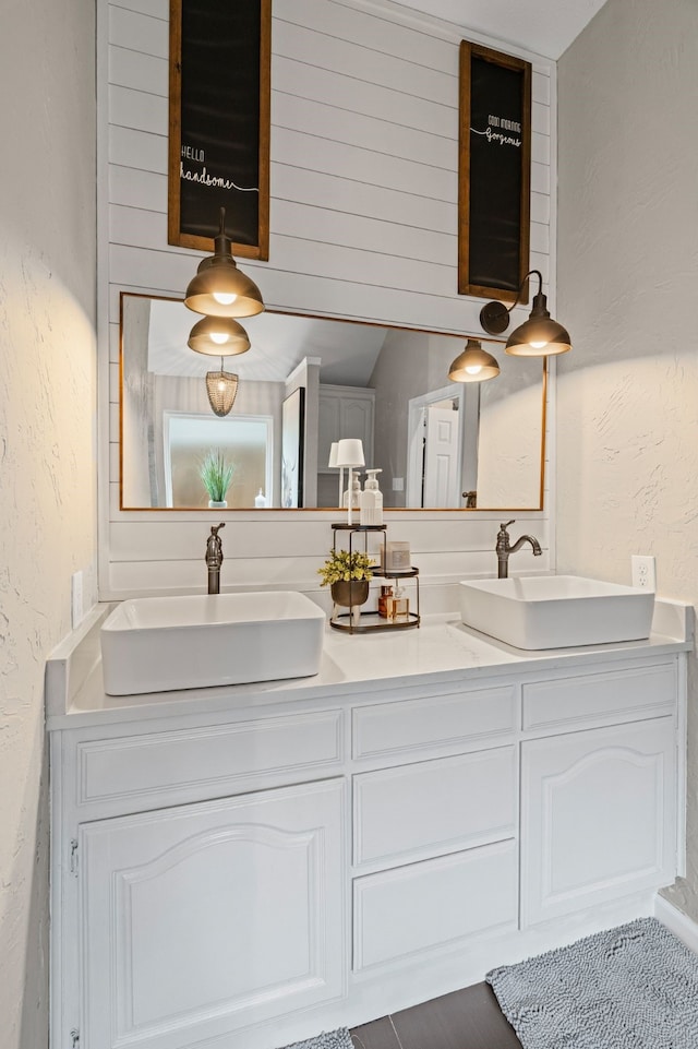 416 Springhill Dr, Hurst, TX 76054 - bathroom featuring a textured wall and double vanity