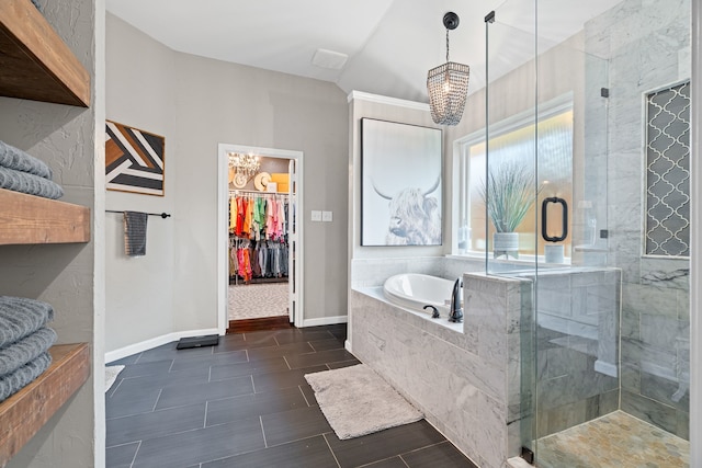 416 Springhill Dr, Hurst, TX 76054 - full bathroom featuring a chandelier, a garden tub, a shower stall, and a walk in closet