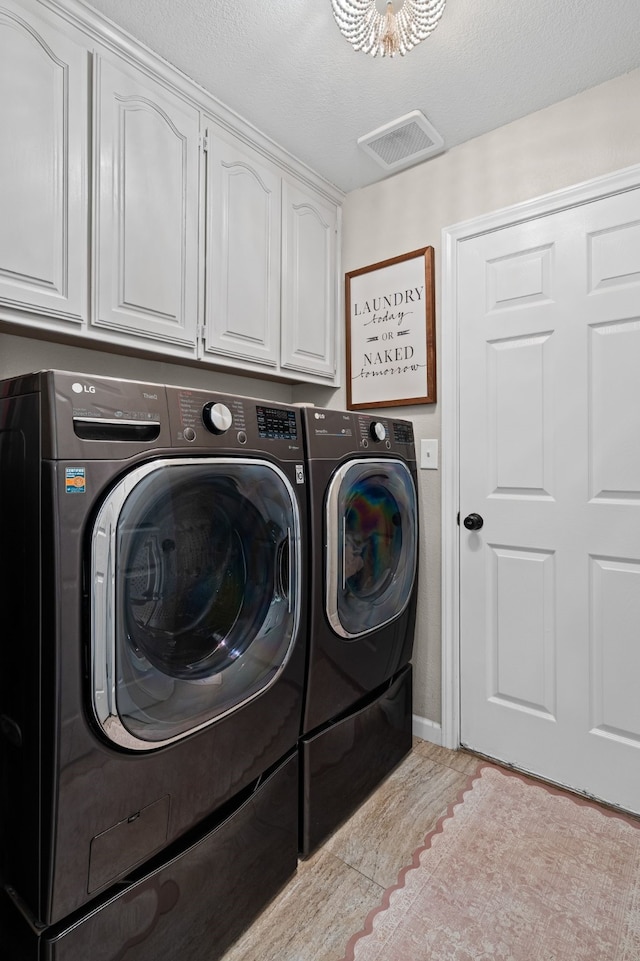 416 Springhill Dr, Hurst, TX 76054 - washroom featuring washing machine and dryer, cabinet space, and light tile patterned floors