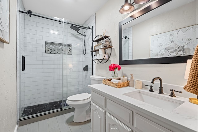 416 Springhill Dr, Hurst, TX 76054 - bathroom featuring vanity, a stall shower, tile patterned flooring, and a textured wall