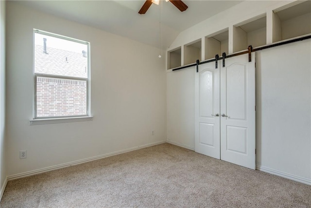 1300 Meadow Ranch Rd, Mckinney, TX 75071 - unfurnished bedroom featuring carpet flooring, a barn door, a ceiling fan, and a closet