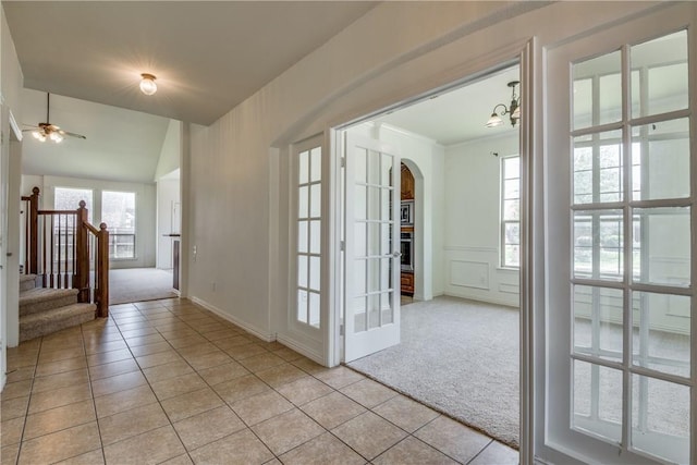 1300 Meadow Ranch Rd, Mckinney, TX 75071 - entrance foyer featuring light colored carpet, light tile patterned floors, arched walkways, and stairs