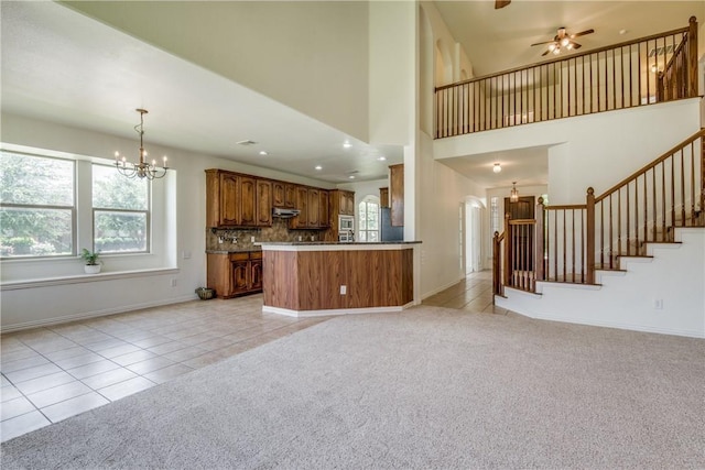 1300 Meadow Ranch Rd, Mckinney, TX 75071 - unfurnished living room featuring light tile patterned flooring, a chandelier, healthy amount of natural light, stairway, and a towering ceiling