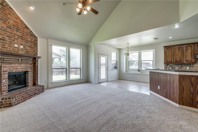 1300 Meadow Ranch Rd, Mckinney, TX 75071 - unfurnished living room featuring light carpet, a chandelier, ceiling fan, a fireplace, and high vaulted ceiling