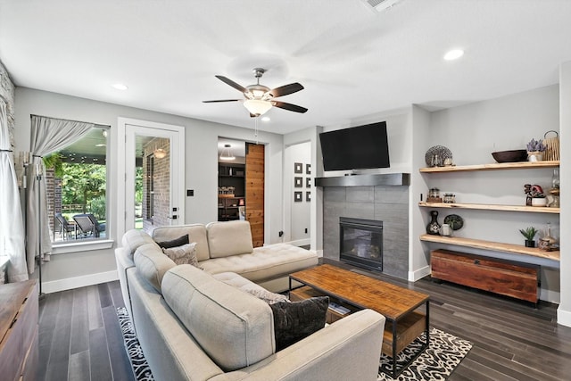 1521 Twistleaf Rd, Flower Mound, TX 76226 - living room with ceiling fan, a tiled fireplace, dark wood-style floors, and recessed lighting