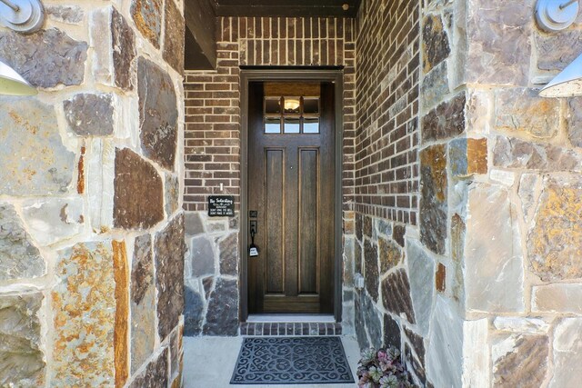 1521 Twistleaf Rd, Flower Mound, TX 76226 - doorway to property with stone siding and brick siding