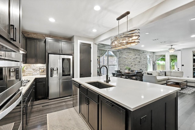 1521 Twistleaf Rd, Flower Mound, TX 76226 - kitchen featuring appliances with stainless steel finishes, wood finished floors, light countertops, recessed lighting, and tasteful backsplash
