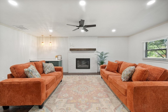 1205 Columbia Cir, Corsicana, TX 75110 - living room with recessed lighting, a ceiling fan, a brick fireplace, and ornamental molding