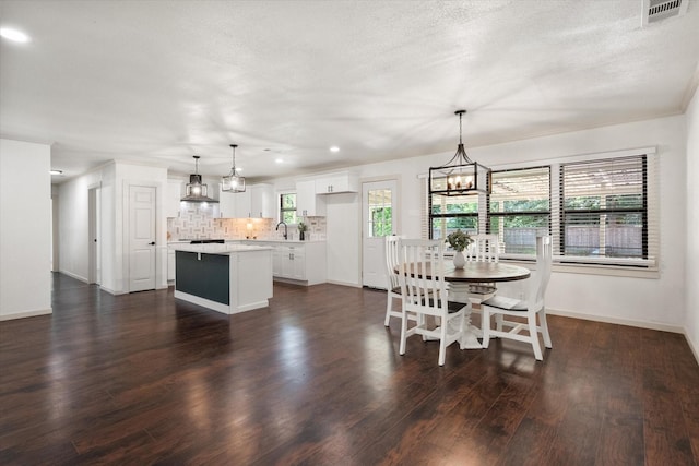 1205 Columbia Cir, Corsicana, TX 75110 - dining room with a chandelier, dark wood-style flooring, and recessed lighting