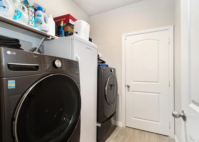 505 Reatta Dr, Justin, TX 76247 - washroom with washing machine and clothes dryer and light wood finished floors