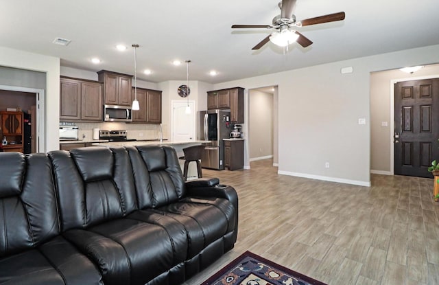 505 Reatta Dr, Justin, TX 76247 - living area with ceiling fan, light wood-style flooring, and recessed lighting