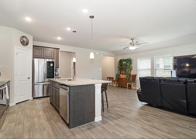 505 Reatta Dr, Justin, TX 76247 - kitchen featuring stainless steel appliances, a ceiling fan, light wood-type flooring, open floor plan, and recessed lighting