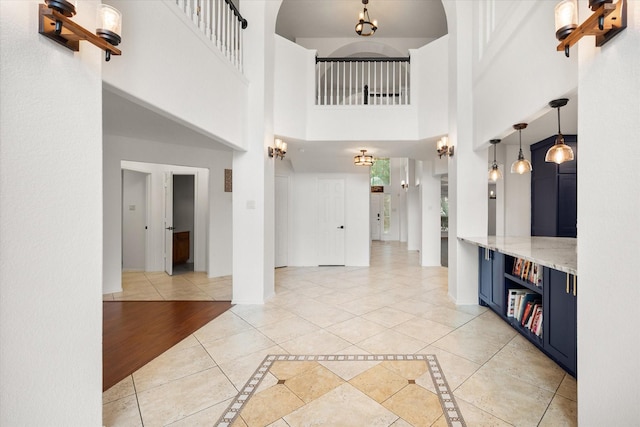4412 Corner Brook Ln, Fort Worth, TX 76123 - entryway featuring inlaid floor details, a high ceiling, and light tile patterned flooring
