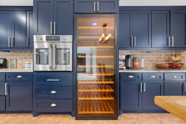 4412 Corner Brook Ln, Fort Worth, TX 76123 - kitchen featuring oven, light tile patterned floors, beverage cooler, and backsplash