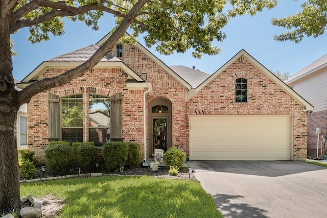 2823 Coteau Way, Dallas, TX 75227 - view of front of home with brick siding, driveway, an attached garage, and roof with shingles
