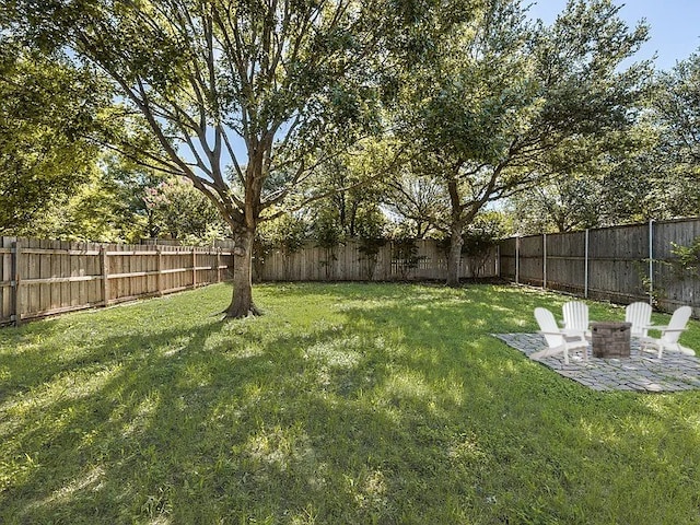 2823 Coteau Way, Dallas, TX 75227 - fenced backyard featuring a patio area and a fire pit