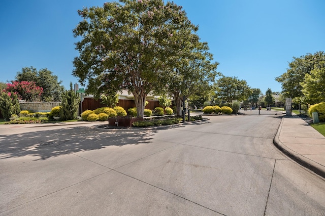 2823 Coteau Way, Dallas, TX 75227 - view of concrete street featuring curbs, sidewalks, and a gated entry