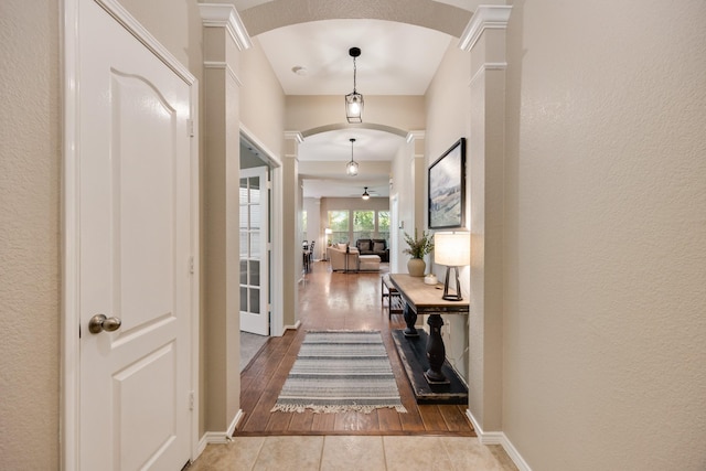 2823 Coteau Way, Dallas, TX 75227 - entrance foyer with arched walkways, wood finished floors, ceiling fan, and ornate columns