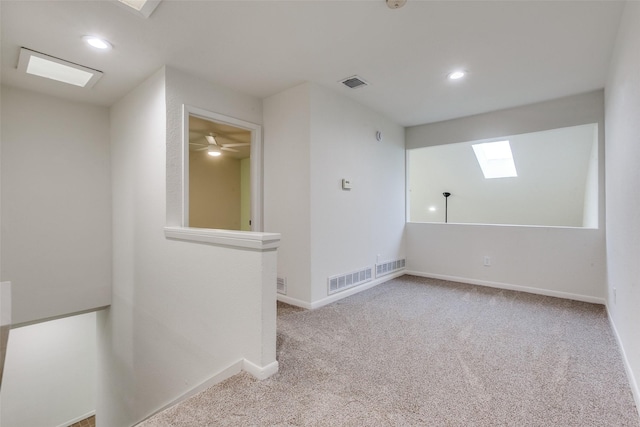 7450 Holly Hill Dr Unit 115, Dallas, TX 75231 - unfurnished room with carpet, a skylight, and recessed lighting