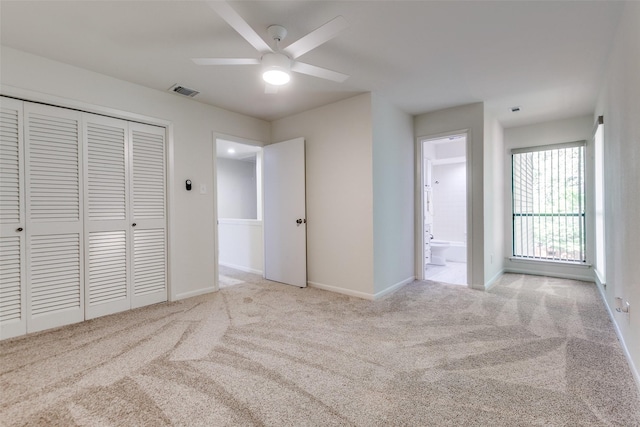7450 Holly Hill Dr Unit 115, Dallas, TX 75231 - unfurnished bedroom with carpet floors, a closet, ensuite bath, and a ceiling fan