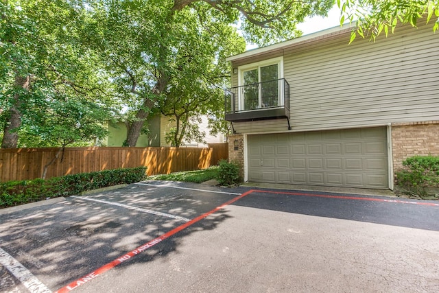 7450 Holly Hill Dr Unit 115, Dallas, TX 75231 - view of front of property with brick siding and a garage