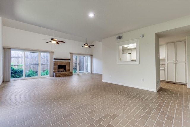 7450 Holly Hill Dr Unit 115, Dallas, TX 75231 - unfurnished living room featuring a brick fireplace, ceiling fan, brick patterned floors, recessed lighting, and plenty of natural light