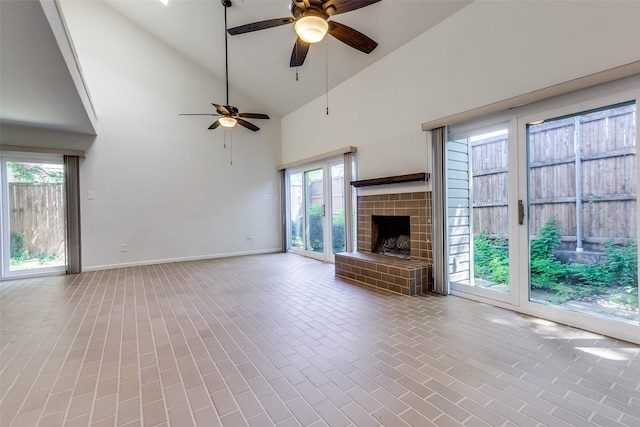 7450 Holly Hill Dr Unit 115, Dallas, TX 75231 - unfurnished living room with ceiling fan, high vaulted ceiling, and a brick fireplace