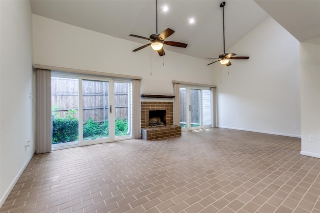 7450 Holly Hill Dr Unit 115, Dallas, TX 75231 - unfurnished living room featuring ceiling fan, high vaulted ceiling, brick patterned flooring, a fireplace, and healthy amount of natural light
