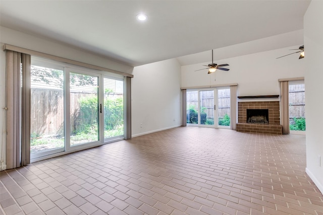 7450 Holly Hill Dr Unit 115, Dallas, TX 75231 - unfurnished living room featuring a ceiling fan, brick patterned floors, a brick fireplace, recessed lighting, and lofted ceiling