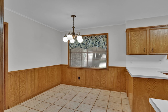 824 Captain Shreve Dr, Shreveport, LA 71105 - unfurnished dining area featuring wainscoting, a chandelier, ornamental molding, wood walls, and light tile patterned floors