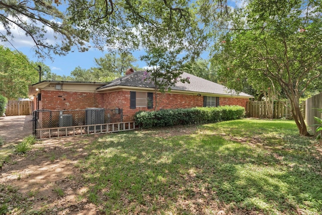 824 Captain Shreve Dr, Shreveport, LA 71105 - back of house featuring brick siding, a chimney, and a fenced backyard