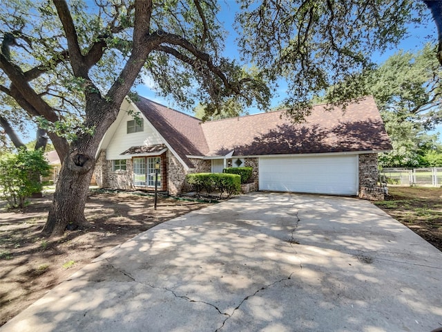 5941 Ten Mile Bridge Rd, Fort Worth, TX 76135 - view of front of home featuring concrete driveway, a garage, brick siding, and roof with shingles