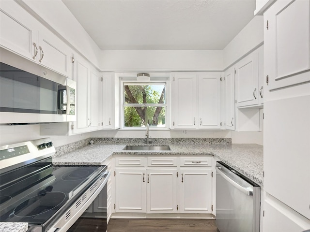 5941 Ten Mile Bridge Rd, Fort Worth, TX 76135 - kitchen with stainless steel appliances, white cabinetry, dark wood-type flooring, and light stone counters