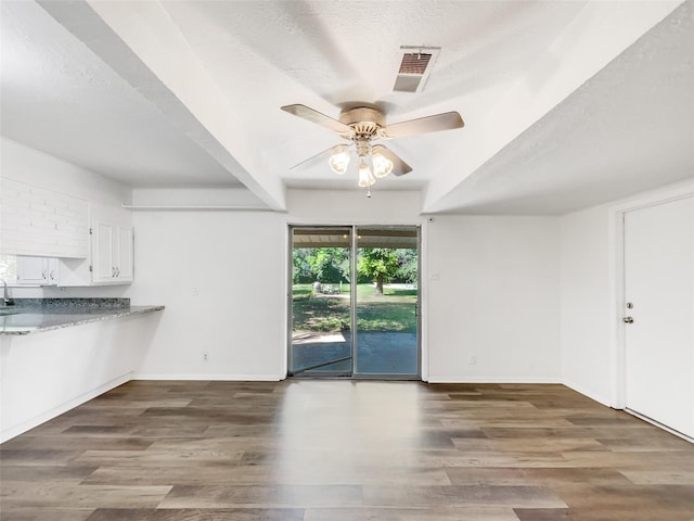 5941 Ten Mile Bridge Rd, Fort Worth, TX 76135 - unfurnished living room with ceiling fan, wood finished floors, and a textured ceiling