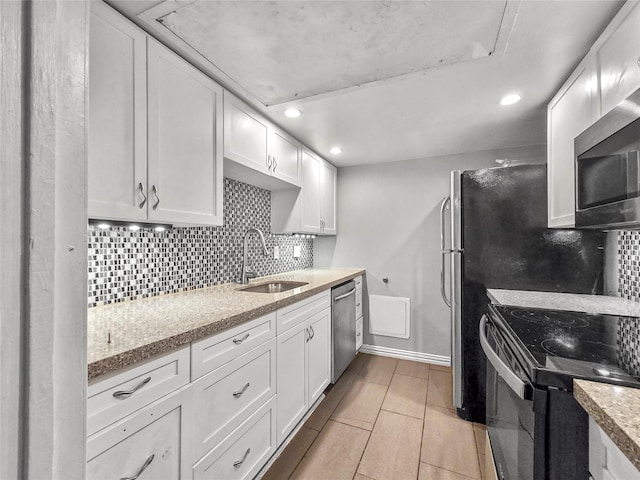 6620 Eastridge Dr Unit 219, Dallas, TX 75231 - kitchen featuring stainless steel appliances, tasteful backsplash, white cabinets, recessed lighting, and light stone counters