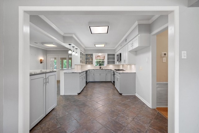 1215 Columbia Cir, Corsicana, TX 75110 - kitchen featuring a peninsula, stainless steel microwave, decorative backsplash, ornamental molding, and glass insert cabinets