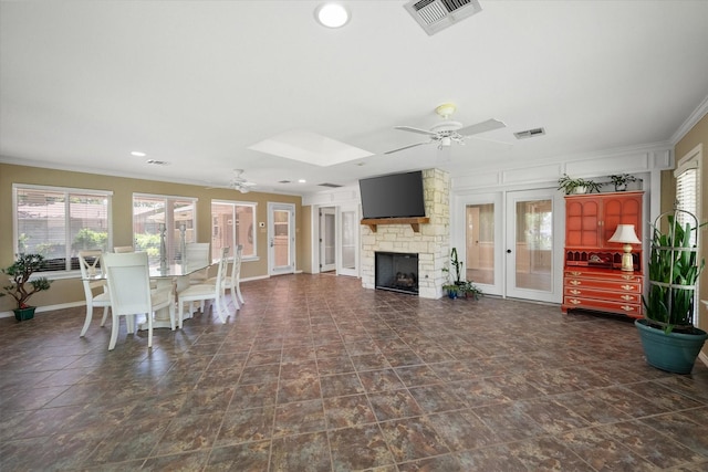 1215 Columbia Cir, Corsicana, TX 75110 - dining room with a ceiling fan, ornamental molding, a fireplace, french doors, and recessed lighting