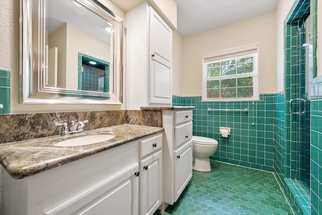1215 Columbia Cir, Corsicana, TX 75110 - full bath with vanity, tile patterned floors, a shower stall, tile walls, and wainscoting