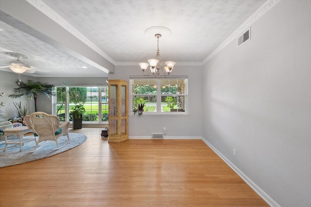 1215 Columbia Cir, Corsicana, TX 75110 - interior space with a chandelier, light wood finished floors, a textured ceiling, and ornamental molding