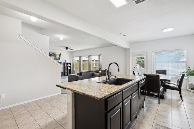 616 Cameron Way, Azle, TX 76020 - kitchen featuring light tile patterned flooring, healthy amount of natural light, a center island with sink, and dishwashing machine