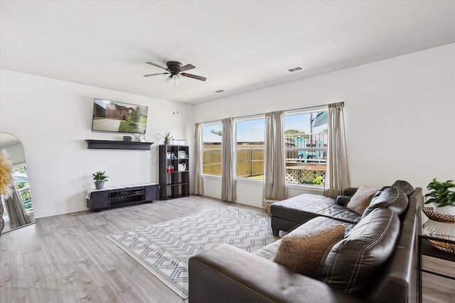 616 Cameron Way, Azle, TX 76020 - living room with ceiling fan, healthy amount of natural light, wood finished floors, and arched walkways