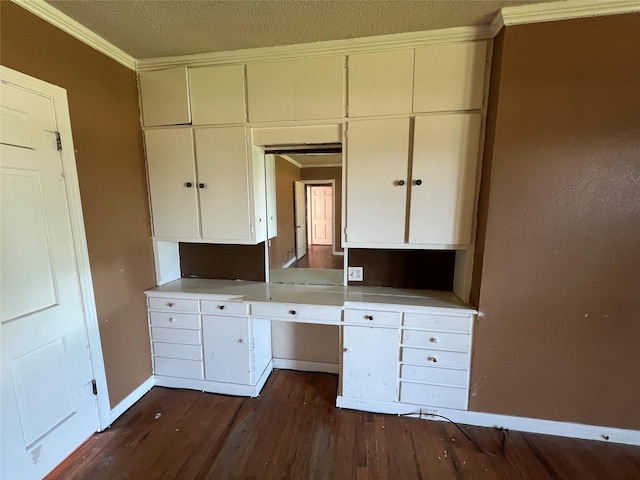 2928 Pine Ave, Waco, TX 76708 - kitchen with ornamental molding, dark wood-type flooring, a textured ceiling, light countertops, and white cabinetry