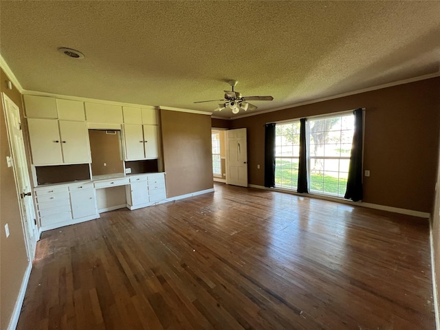 2928 Pine Ave, Waco, TX 76708 - unfurnished living room featuring a textured ceiling, ornamental molding, dark wood-style floors, built in study area, and ceiling fan
