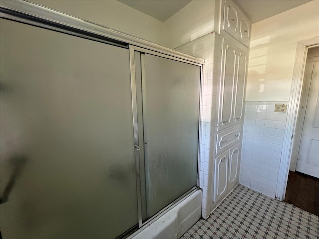 2928 Pine Ave, Waco, TX 76708 - full bathroom with tile walls, shower / bath combination with glass door, and tile patterned flooring