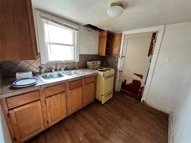 2928 Pine Ave, Waco, TX 76708 - kitchen featuring white electric stove, dark wood finished floors, backsplash, light countertops, and brown cabinetry