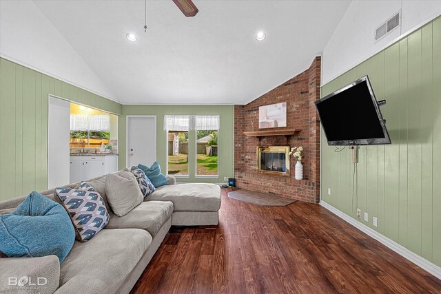 110 Elmview Ln, Haughton, LA 71037 - living room featuring lofted ceiling, wood finished floors, a fireplace, ceiling fan, and wood walls