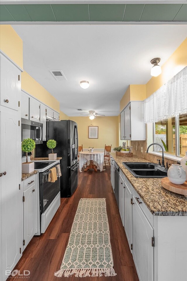 110 Elmview Ln, Haughton, LA 71037 - kitchen featuring appliances with stainless steel finishes, decorative backsplash, and dark wood-style floors